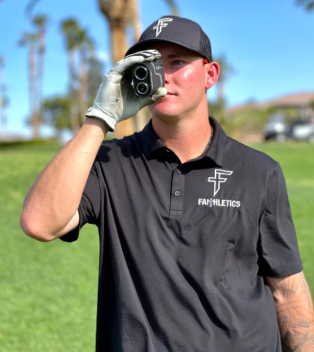 A boy wearing the golf polo by Faithletics in Birdie Black.