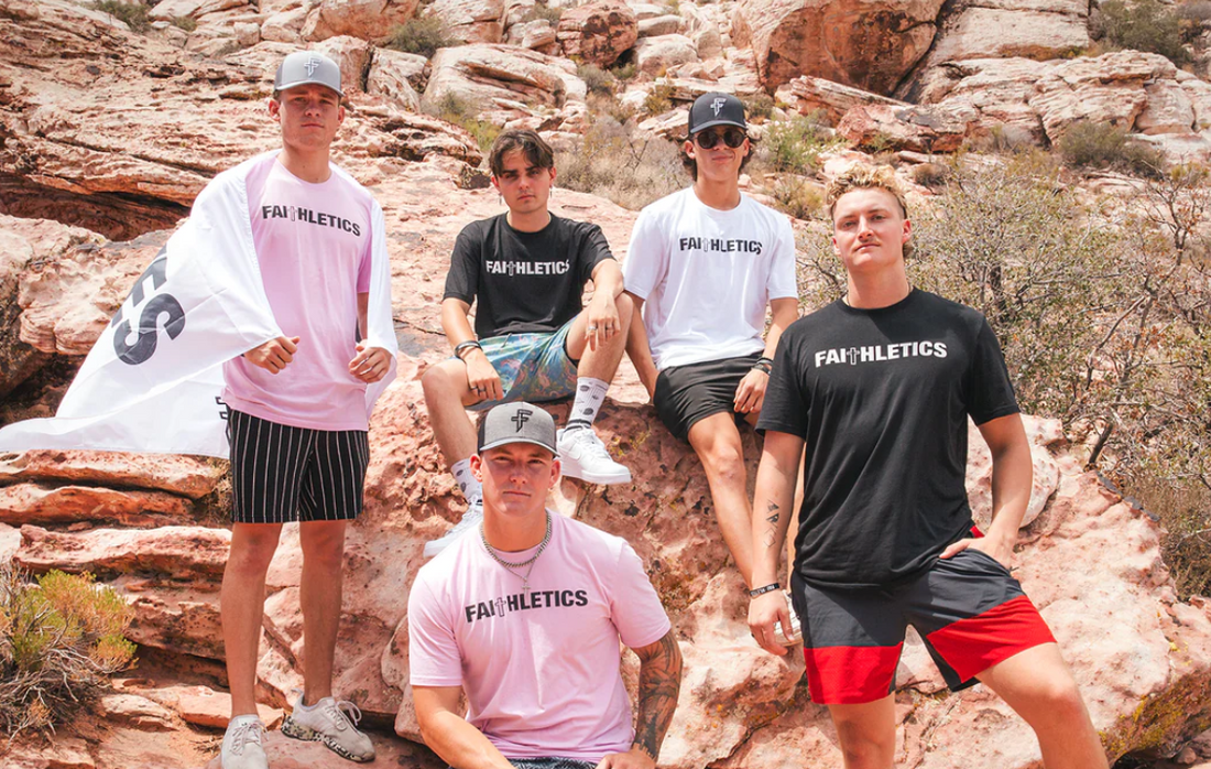 Five boys facing the camera wearing faith-inspired apparel by Faithletics. 